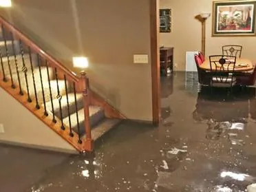 Flooded basement with water covering the floor and stairs