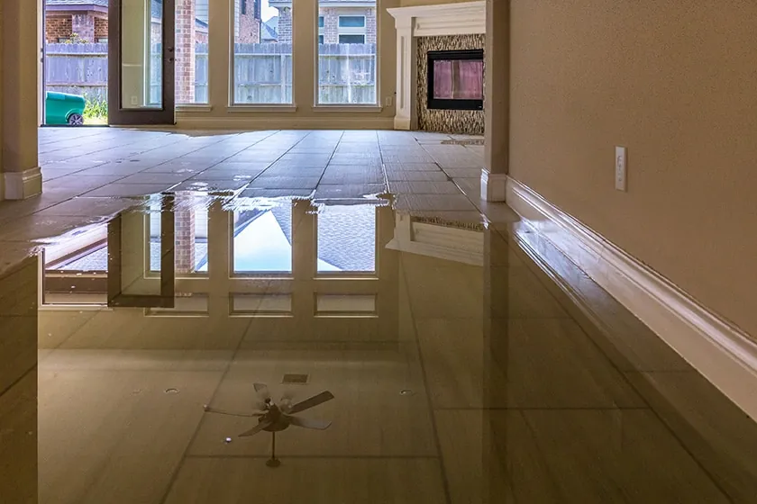 Water pooling across a tiled living room floor
