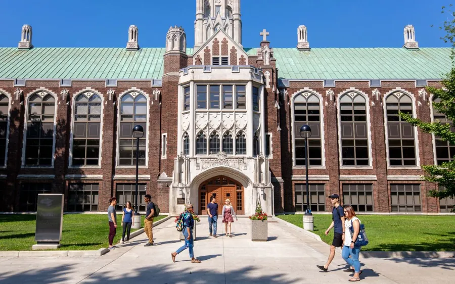 Historic institutional building with students walking in front